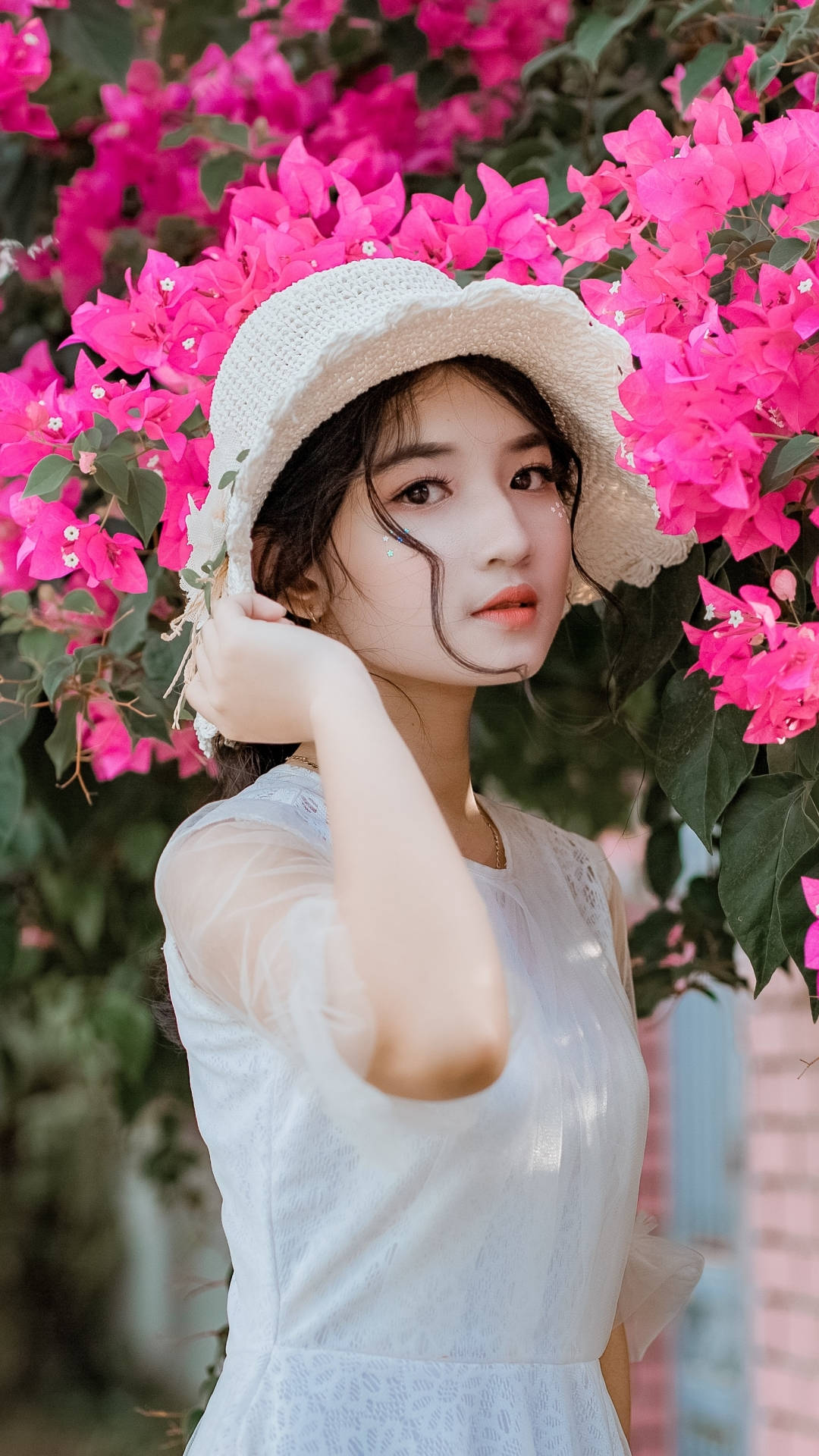 Download Asian Women Posing By The Flowers Wallpaper | Wallpapers.com
